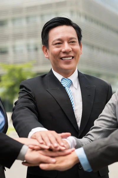 Businessman stacking hands — Stock Photo, Image