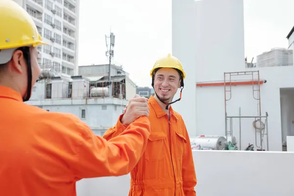 Byggarbetare skakar hand med Colleague — Stockfoto