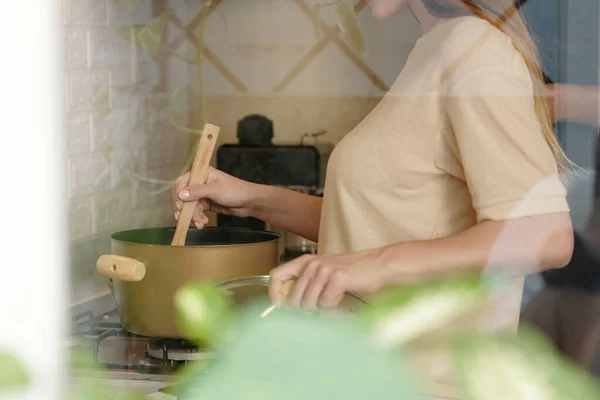 Vrouw koken soep thuis — Stockfoto