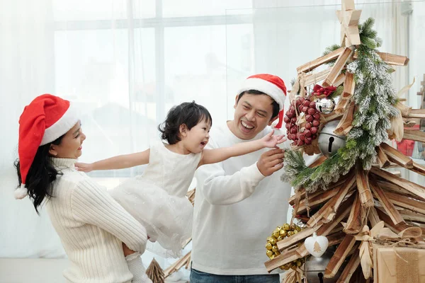 Familie schmückt Weihnachtsbaum — Stockfoto