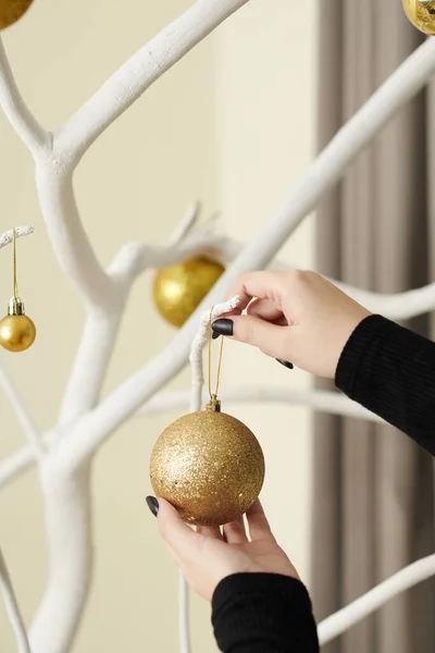 Woman Hanging Golden Sparkling Bauble Tree Branch Painted White Decorating — 图库照片