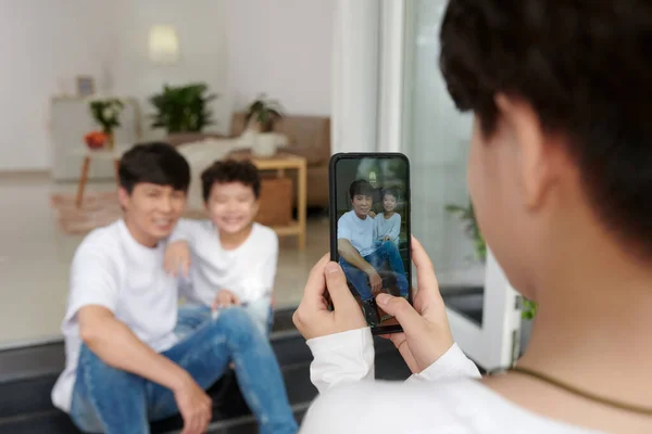 Boy Photographing Father and Brother — Stockfoto