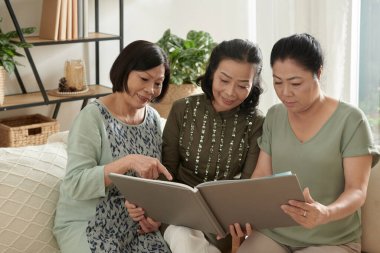 Friends Discussing Old Photos