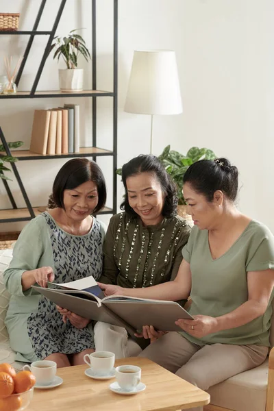 Elderly Friends Discussing Old Photos — 스톡 사진