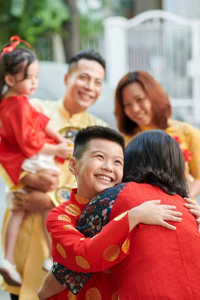 Happy Boy Hugging Grandmother