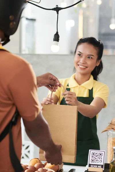 Vendedor que da la orden al repartidor — Foto de Stock