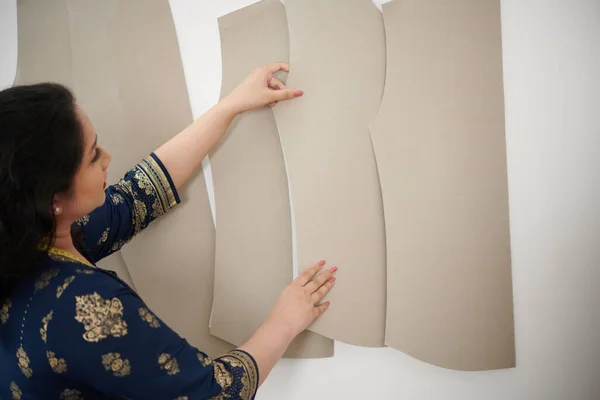 壁から縫製パターンを取るテーラーテイクソー — ストック写真