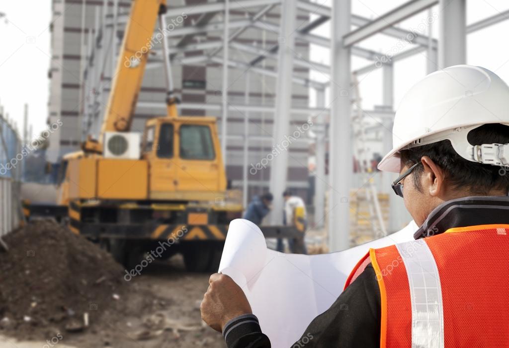 Construction worker cheking plan