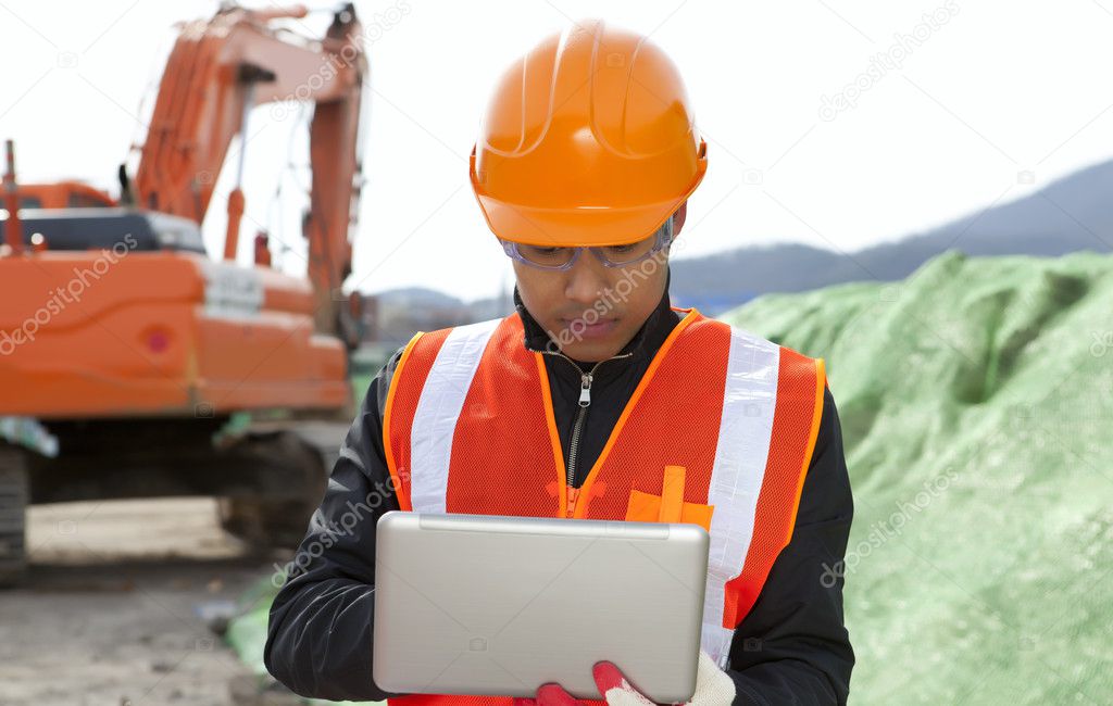 road construction worker using laptop