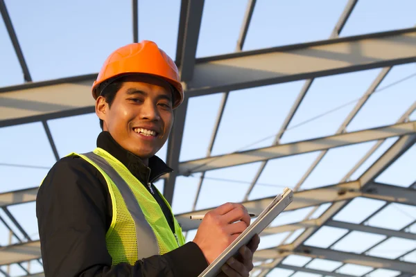 Engineer construction under new building checking plan — Stock Photo, Image