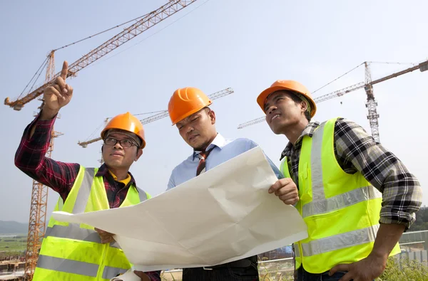 Gruppo architetto discussione fronte di un cantiere — Foto Stock