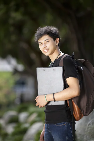 Asian boy holding book on the park — Stock Photo, Image