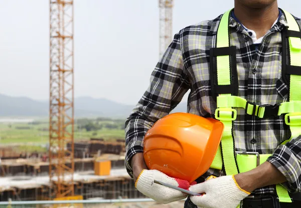 Close up construction worker holding helmet — Stock Photo, Image