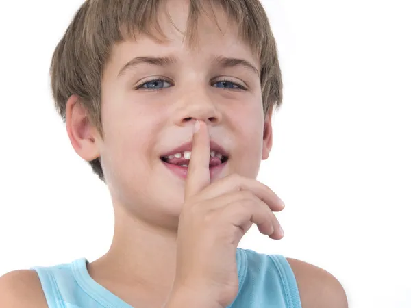 Happy young boy with finger on his mouth — Stock Photo, Image