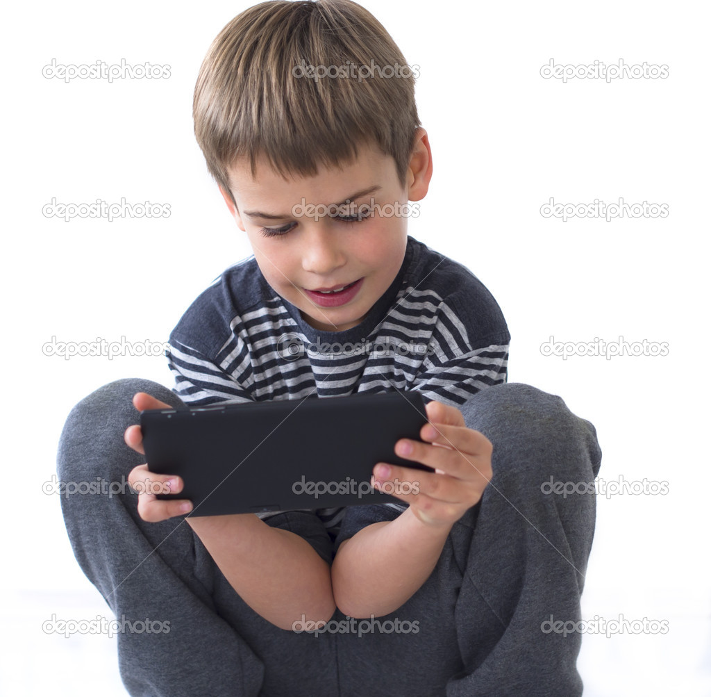 Boy playing games on tablet