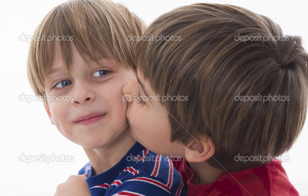 Brother kisses the younger