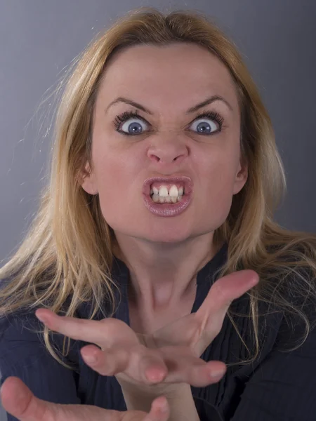 Dangerous crazy woman trying to frighten someone — Stock Photo, Image