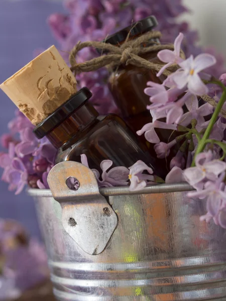 Flores e garrafa em um balde — Fotografia de Stock