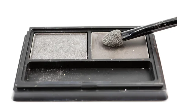 Used brush on eye shadows in black container — Stock Photo, Image