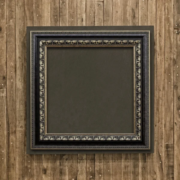 Antique frame on wood background — Stock Photo, Image