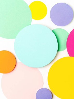 Pastel pembe, mavi, sarı ve yeşil renklerde minimal geometrik şekiller. Soyut parlak renkli kağıt çemberler. Yaratıcı konsept, tasarım ve tasarım için şablon. Metin için boşluk.