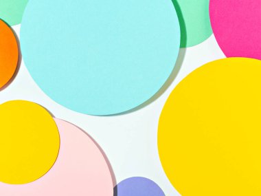 Minimal geometric shapes background in pastel pink, blue, yellow and green colours. Abstract bright colored paper circles. Creative concept, layout, template for styling and design. Space for text.