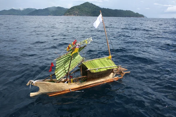 Craft boat floating in ceremony for respect to ancestor of Sea Gypsies