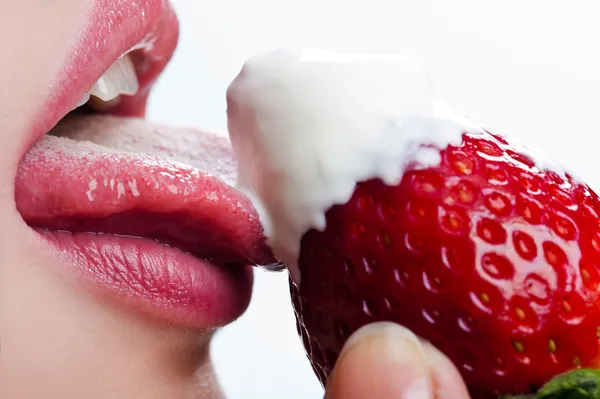 Woman licks sour cream — Stock Photo, Image