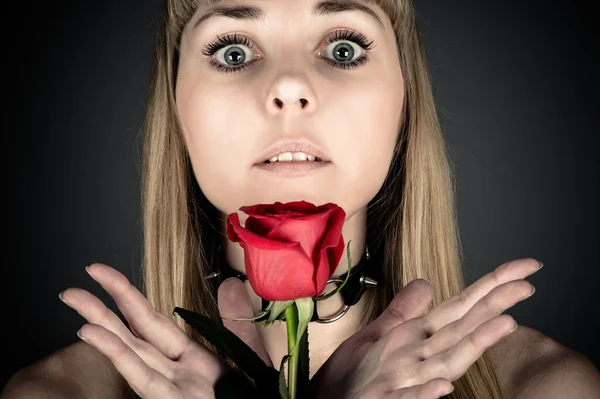 Förvånad kvinna med en ros — Stockfoto