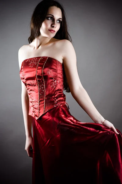 Fashionable woman in a red corset — Stock Photo, Image