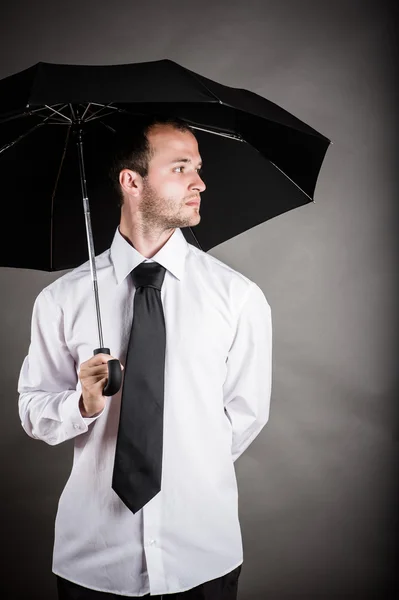 Business man with an umbrella in hand Stock Photo