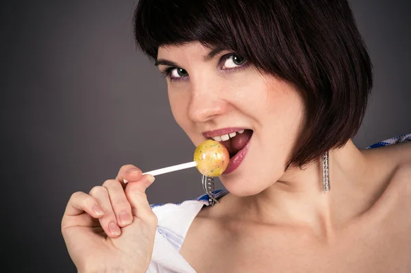 Mooie vrouw met een lolly in de hand — Stockfoto