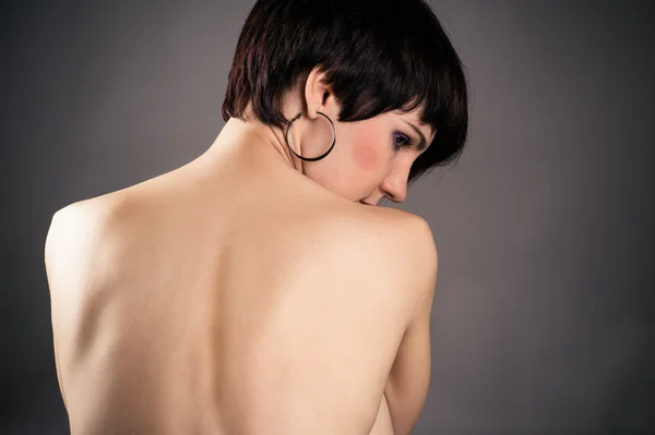 Pensive woman isolated on gray background — Stock Photo, Image