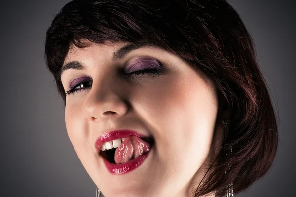Woman seductively licking lips — Stock Photo, Image