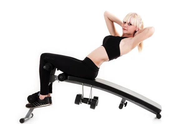 Girl doing exercises on a press — Stock Photo, Image