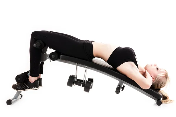 Girl doing exercises on a press — Stock Photo, Image