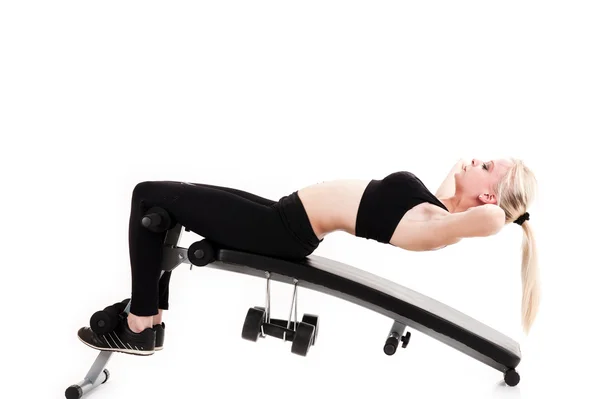 Girl doing exercises on a press — Stock Photo, Image