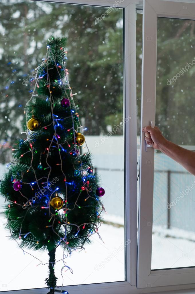 Man opens Christmas window