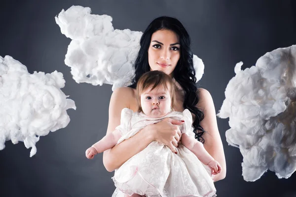 Happy mother with baby over gray — Stock Photo, Image