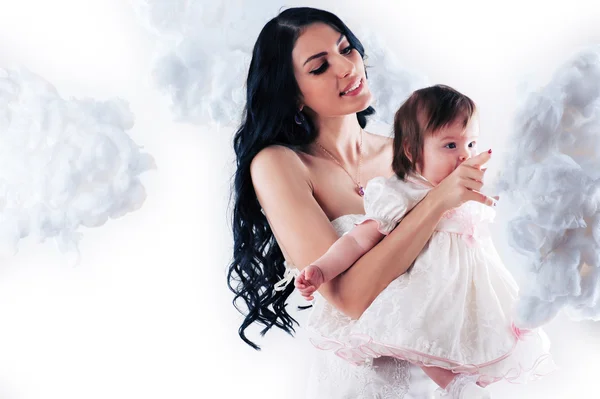 Beautiful mother with a baby in the clouds — Stock Photo, Image