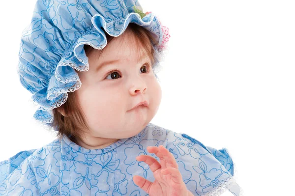 Surprised beautiful baby in a blue dress — Stock Photo, Image