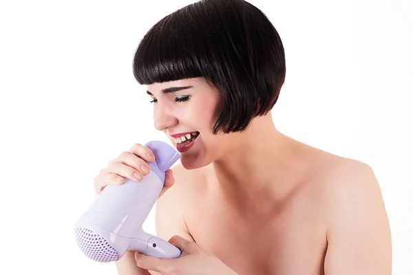 乾燥機に歌っている女性 ロイヤリティフリーのストック写真
