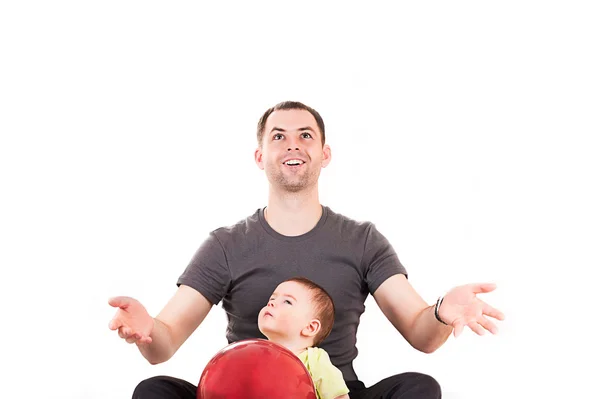 Happy father and son sitting on the floor — Stock Photo, Image