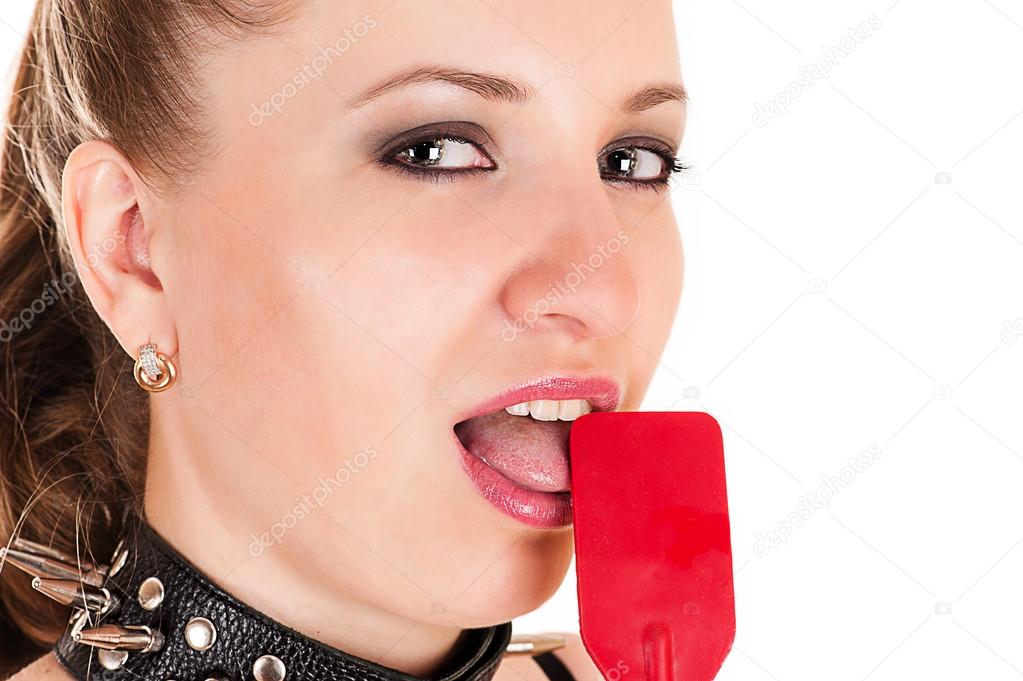 Beautiful woman licking whip