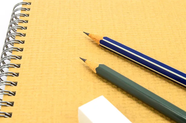 Two Wooden pencil and eraser on recycle notebook on white background. — Stock Photo, Image