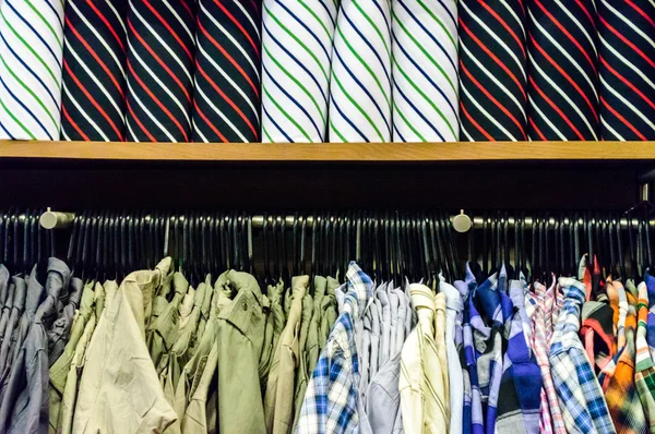 Colorful collection of men's clothes hanging on a rack and Color — Stock Photo, Image