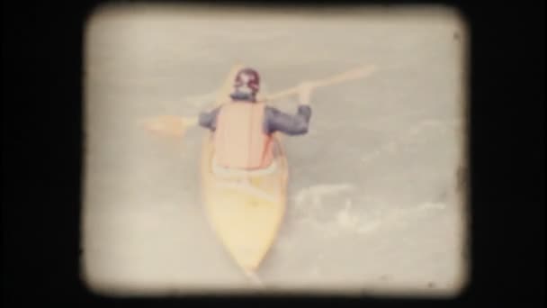 Vintage 8mm. Man kayaking against the current — Stock Video