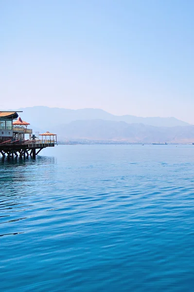 House and receding shore — Stock Photo, Image