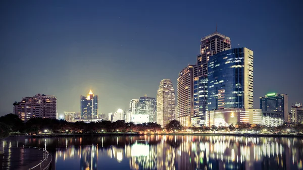 Vintage Tone,City downtown at night with reflection of skyline — Stock Photo, Image