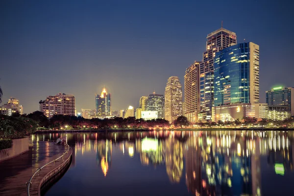 Vintage Tone,City downtown at night with reflection of skyline — Stock Photo, Image